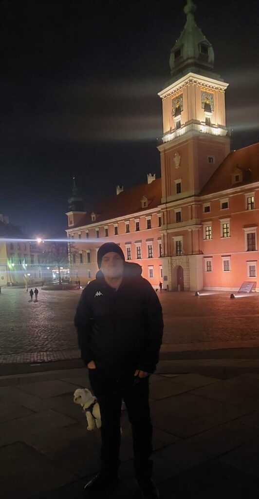 Carl and Sofus the dog on night walk to pink Warsaw Palace