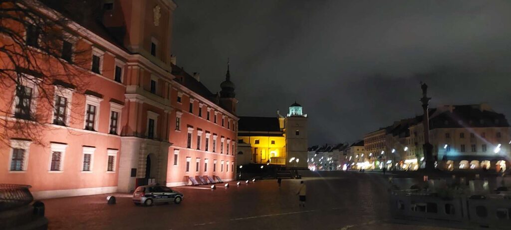 Warsaw Palace at night is lid up so that the pink color shows